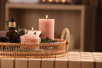 Beautiful composition with different spa products on wicker bench indoors, space for text