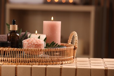 Photo of Beautiful composition with different spa products on wicker bench indoors, space for text