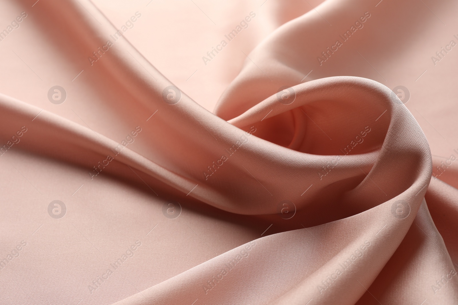 Photo of Crumpled pink silk fabric as background, closeup