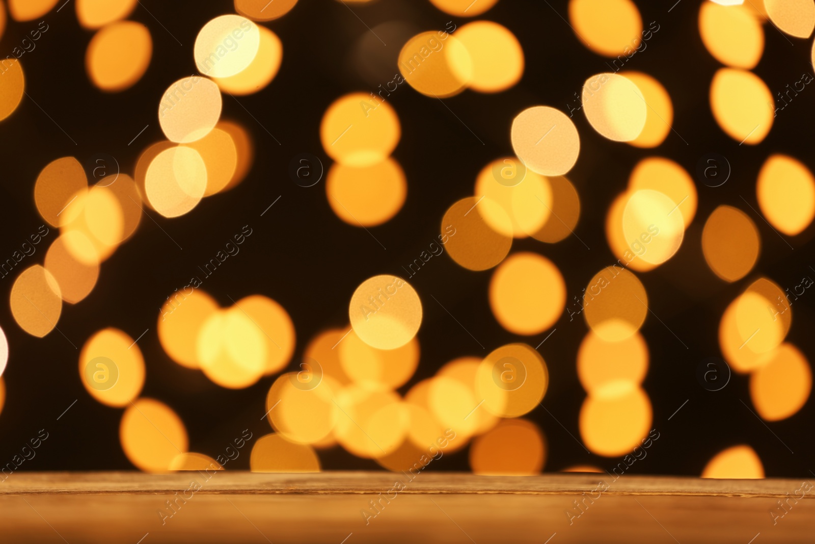 Photo of Empty table against golden bokeh background. Mockup for design