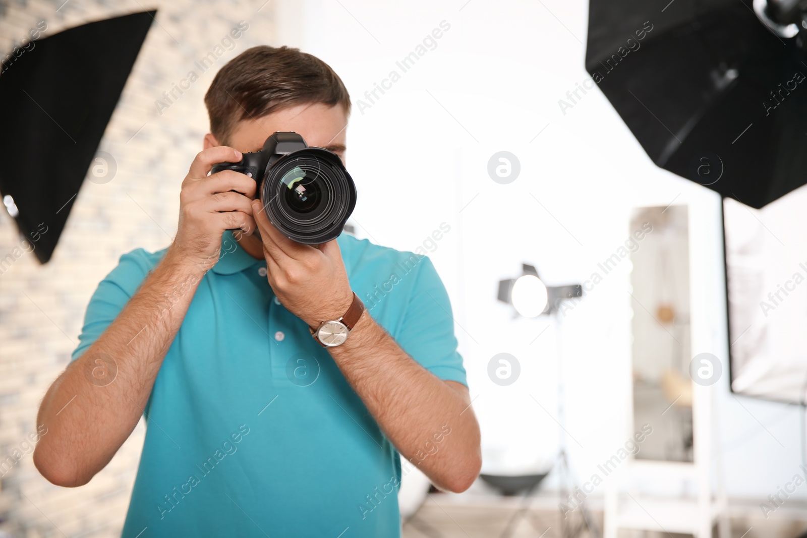 Photo of Professional photographer with camera in photo studio