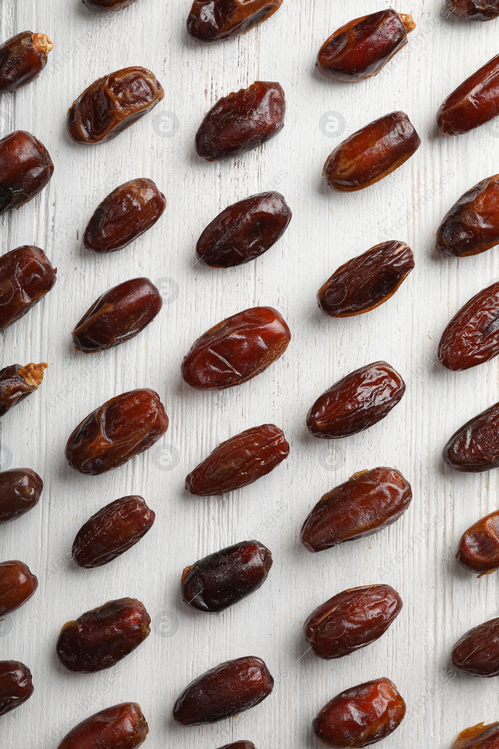 Photo of Flat lay composition with dates on wooden background. Dried fruit as healthy snack