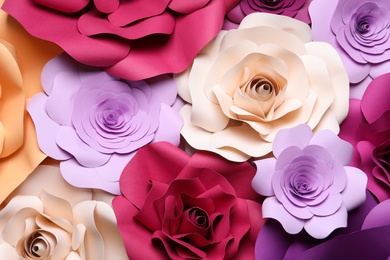 Photo of Different beautiful flowers madepaper as background, above view