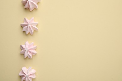 Photo of Delicious meringue cookies on beige background, flat lay. Space for text