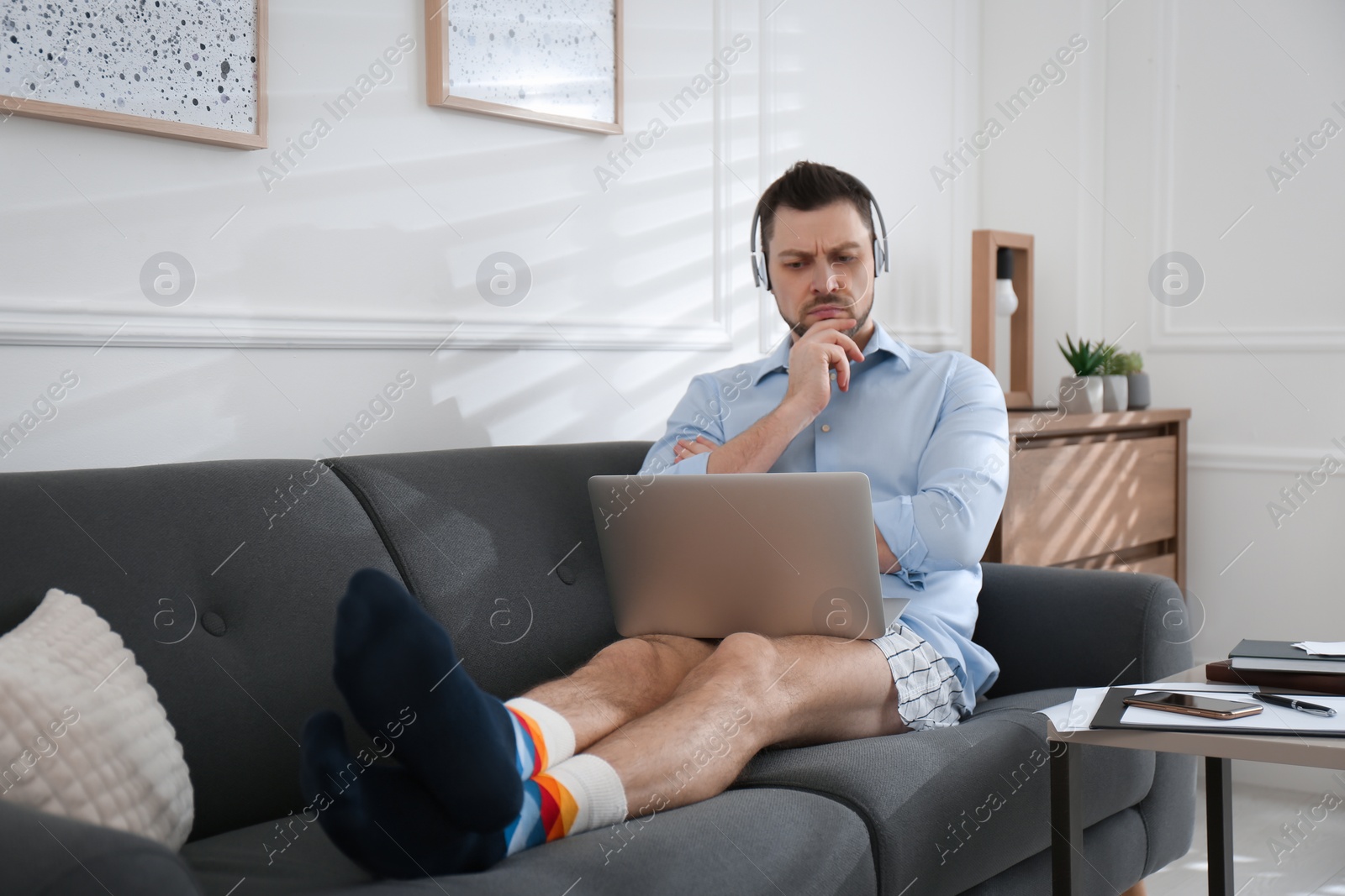Photo of Businessman in underwear pretending to wear formal clothes during video call at home