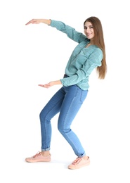 Young woman with magnet attracting people on white background