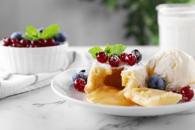 Photo of Tasty vanilla fondant with white chocolate, berries and ice cream on white marble table, closeup