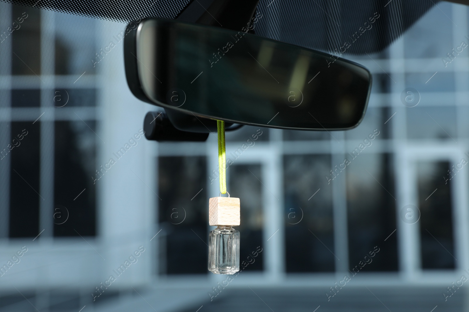 Photo of Air freshener hanging on rear view mirror in car