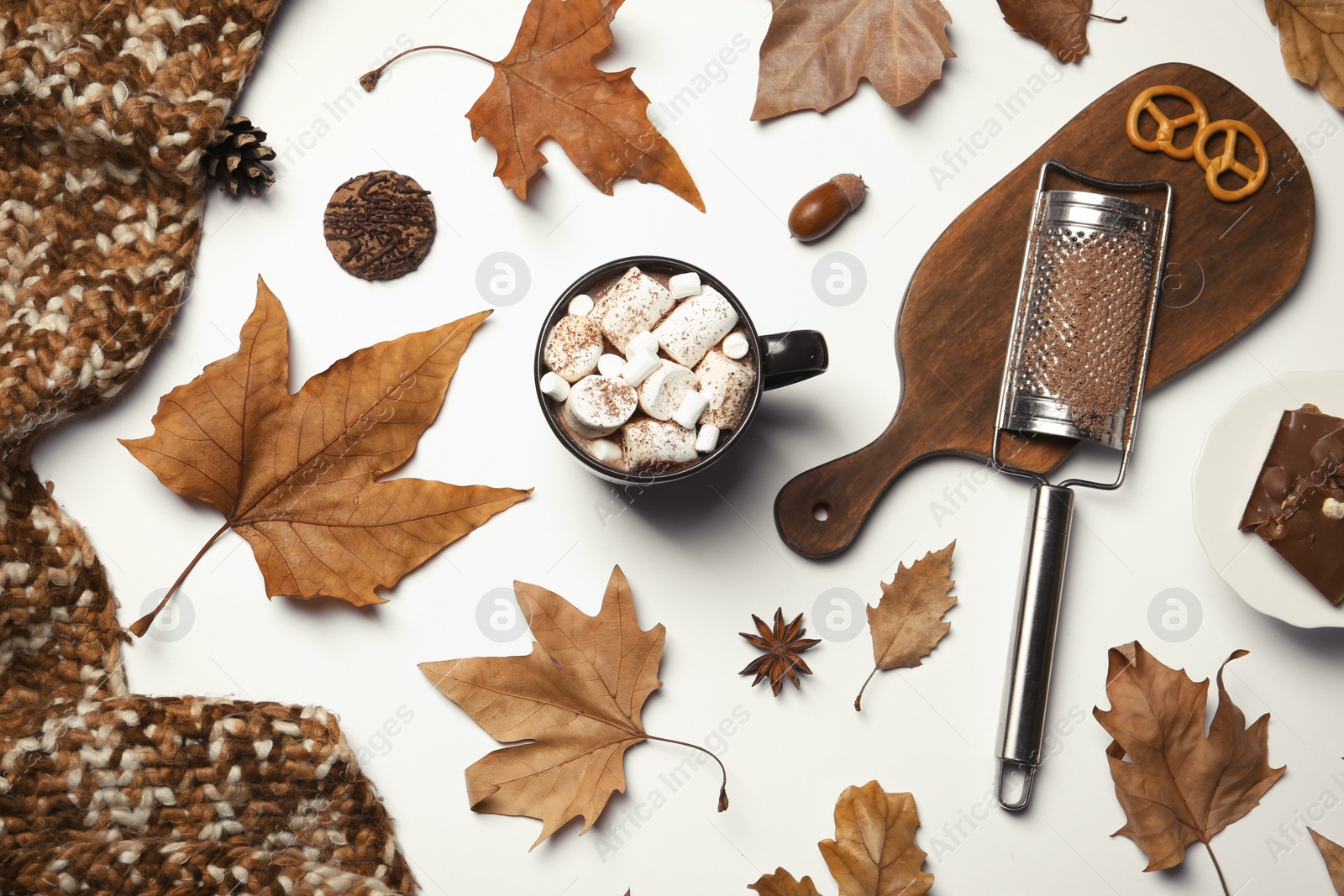 Photo of Flat lay composition with hot cozy drink and autumn leaves on white background