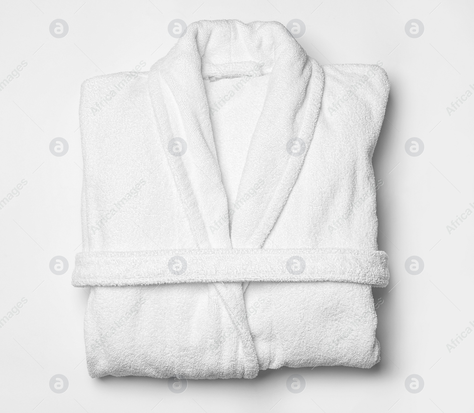 Photo of Clean folded bathrobe on white background, top view