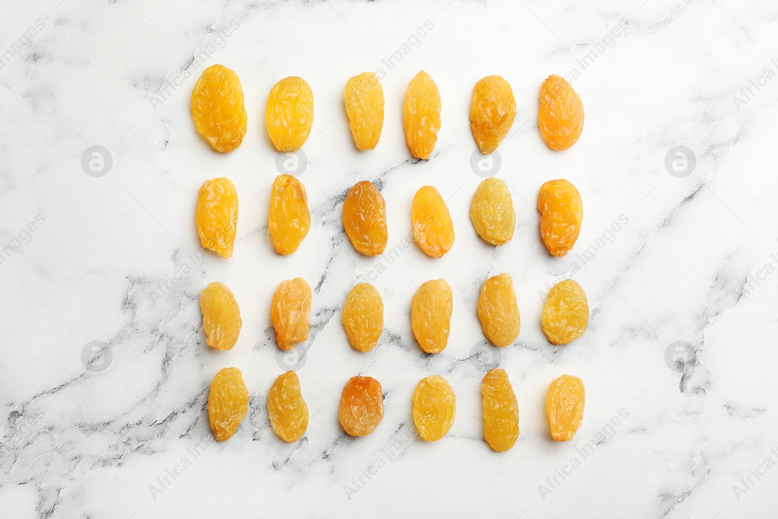 Photo of Flat lay composition with raisins on marble background. Dried fruit as healthy snack