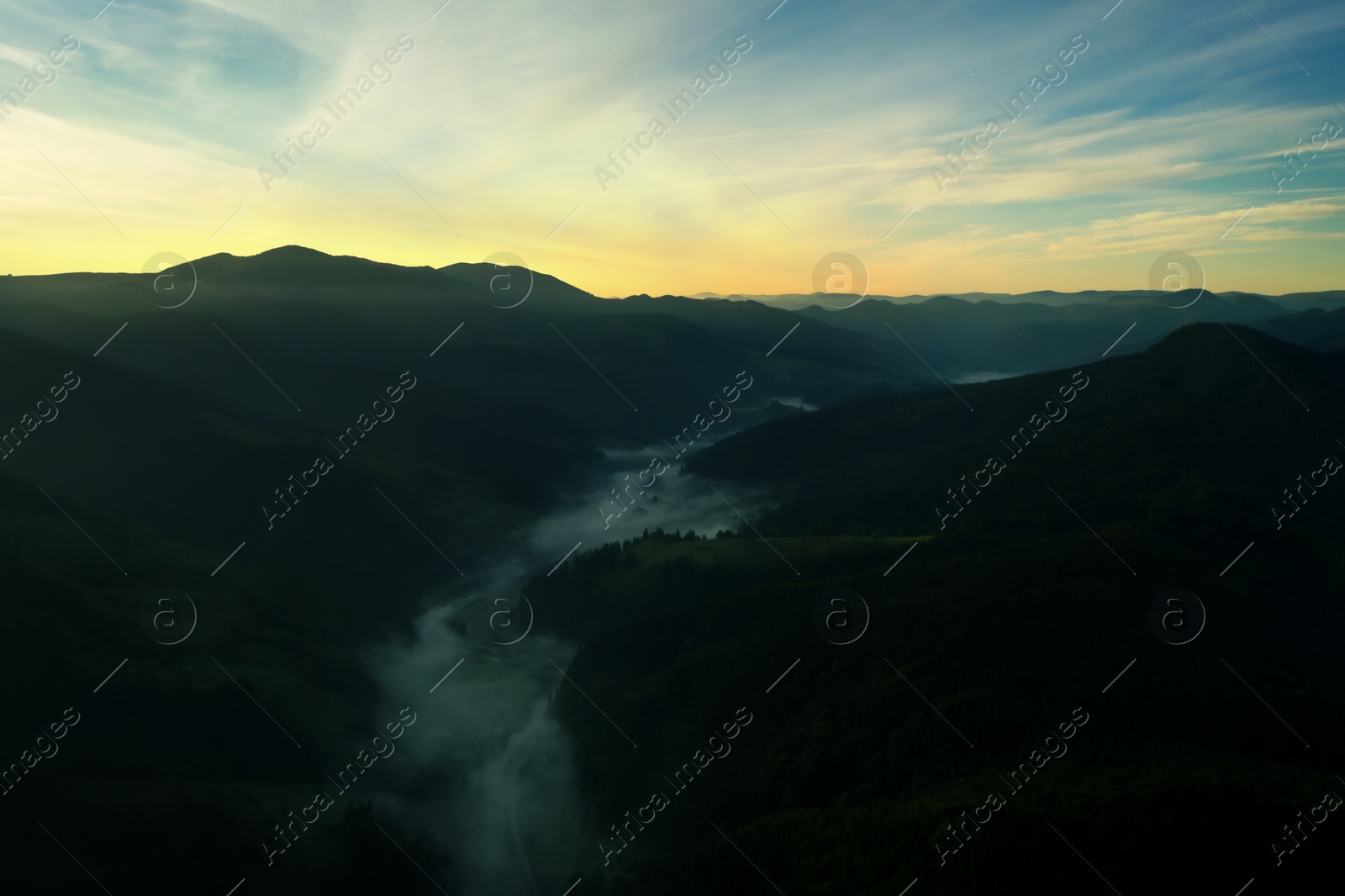 Image of Picturesque view of foggy mountains and beautiful sky in early morning. Drone photography