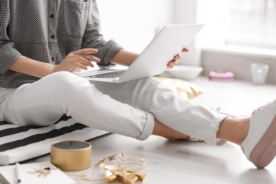 Female blogger with laptop indoors