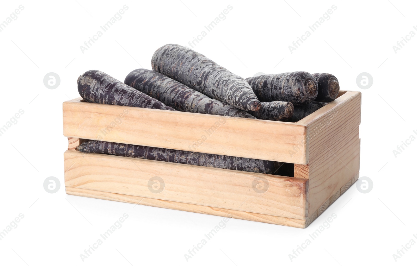 Photo of Raw black carrots in wooden crate isolated on white