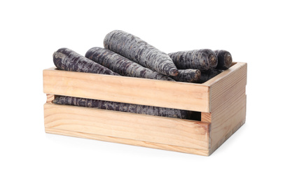 Photo of Raw black carrots in wooden crate isolated on white