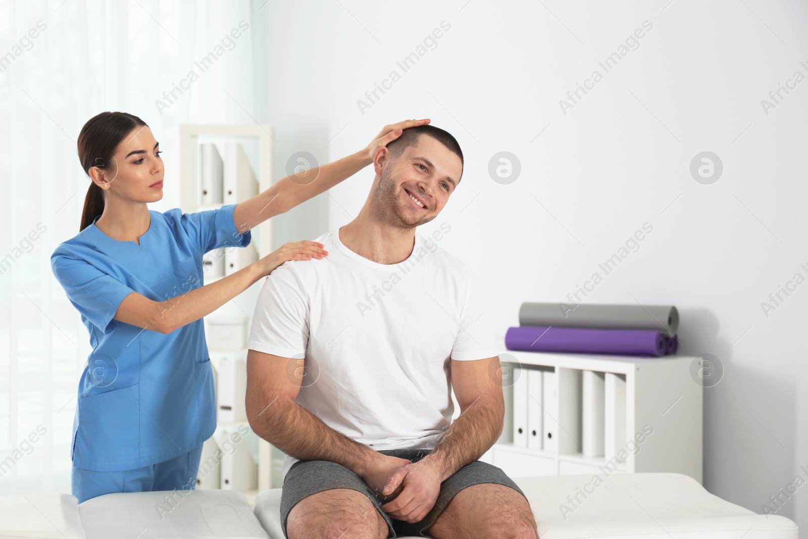 Photo of Doctor working with patient in hospital. Rehabilitation physiotherapy