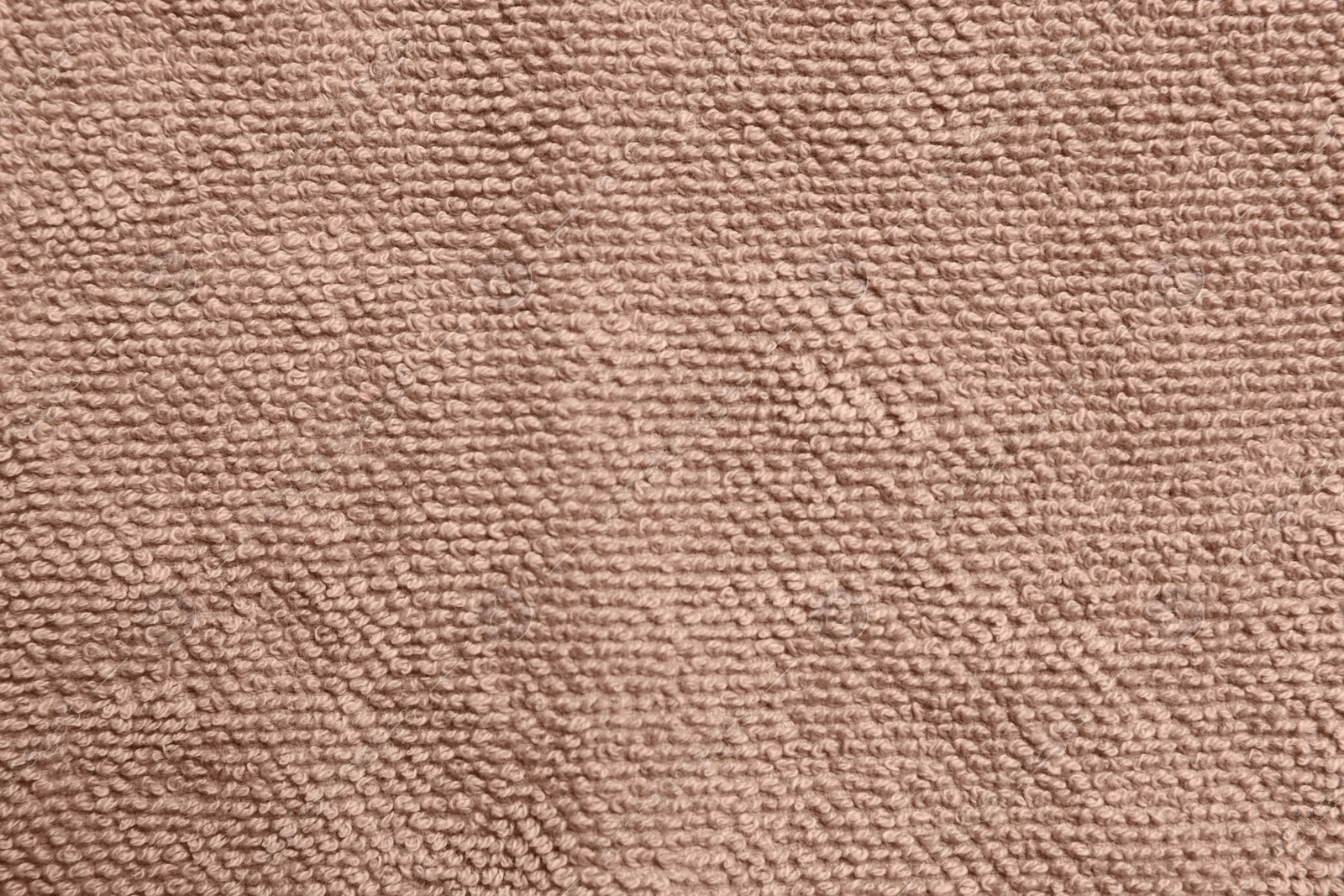 Photo of Soft brown towel as background, top view