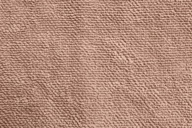 Soft brown towel as background, top view