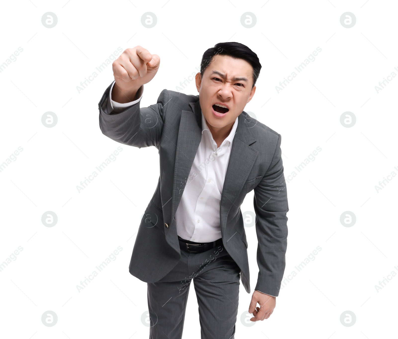 Photo of Angry businessman in suit screaming on white background, low angle view
