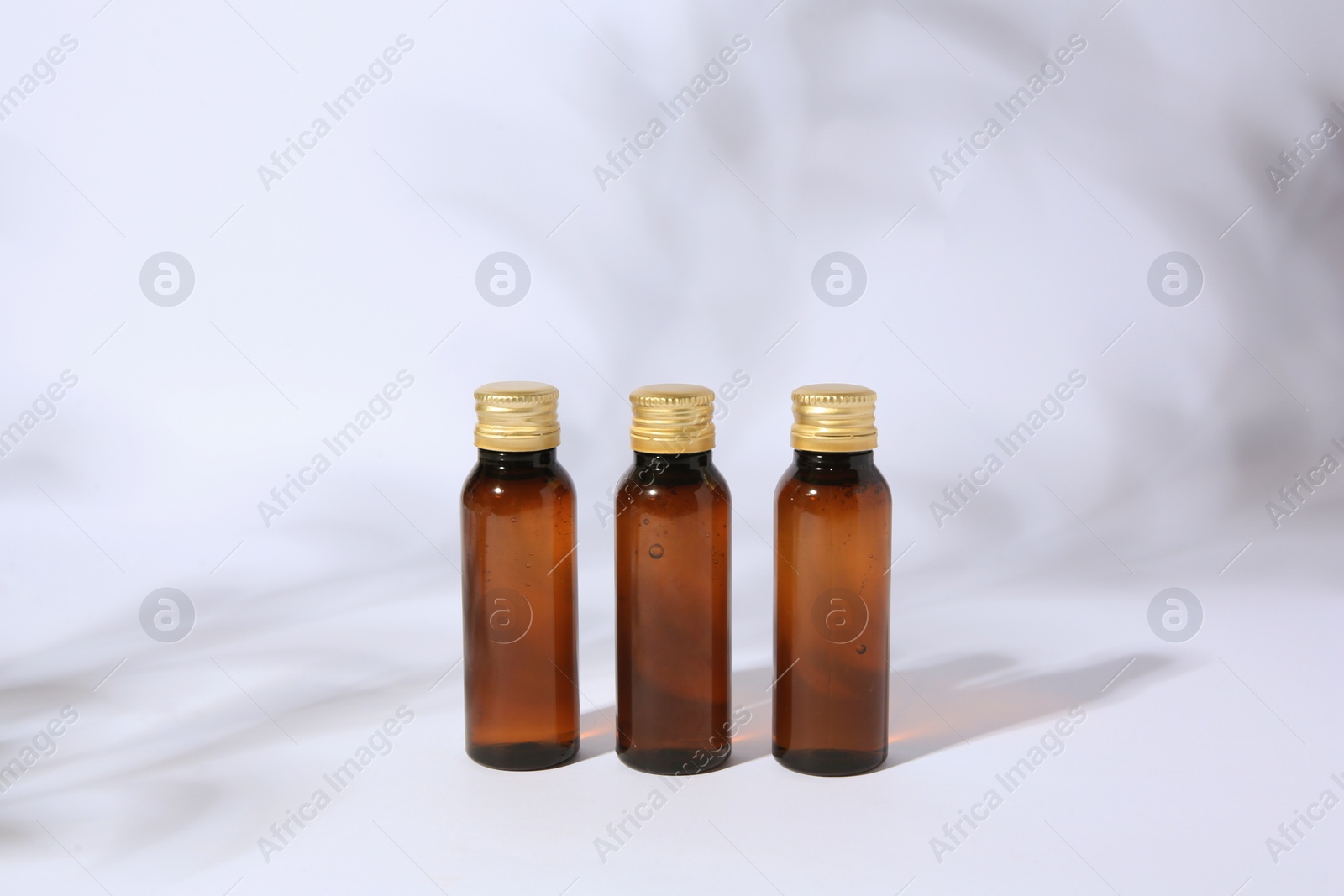 Photo of Bottles of cosmetic products on white background
