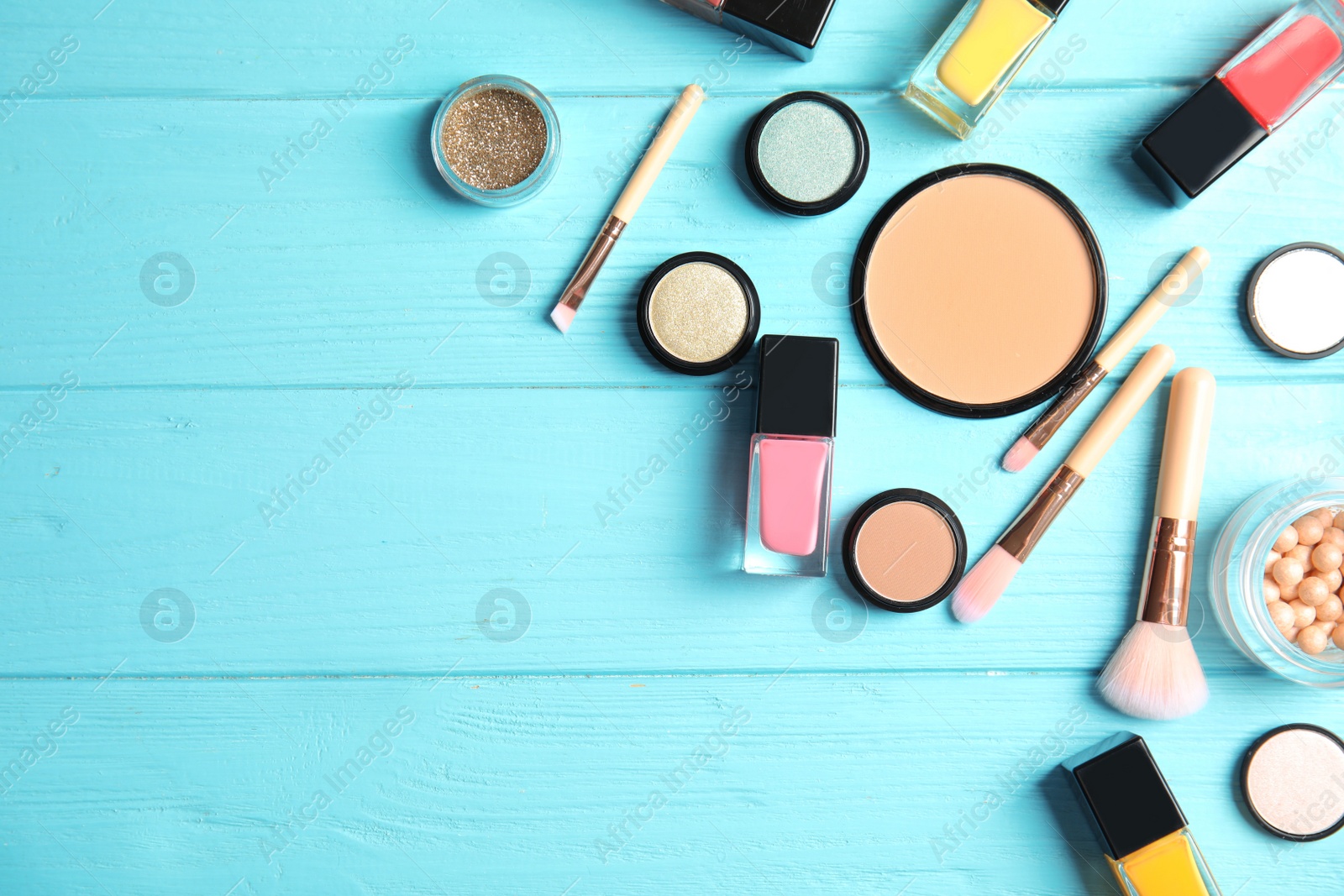 Photo of Flat lay composition with bottles of nail polish, different cosmetics and space for text on color background