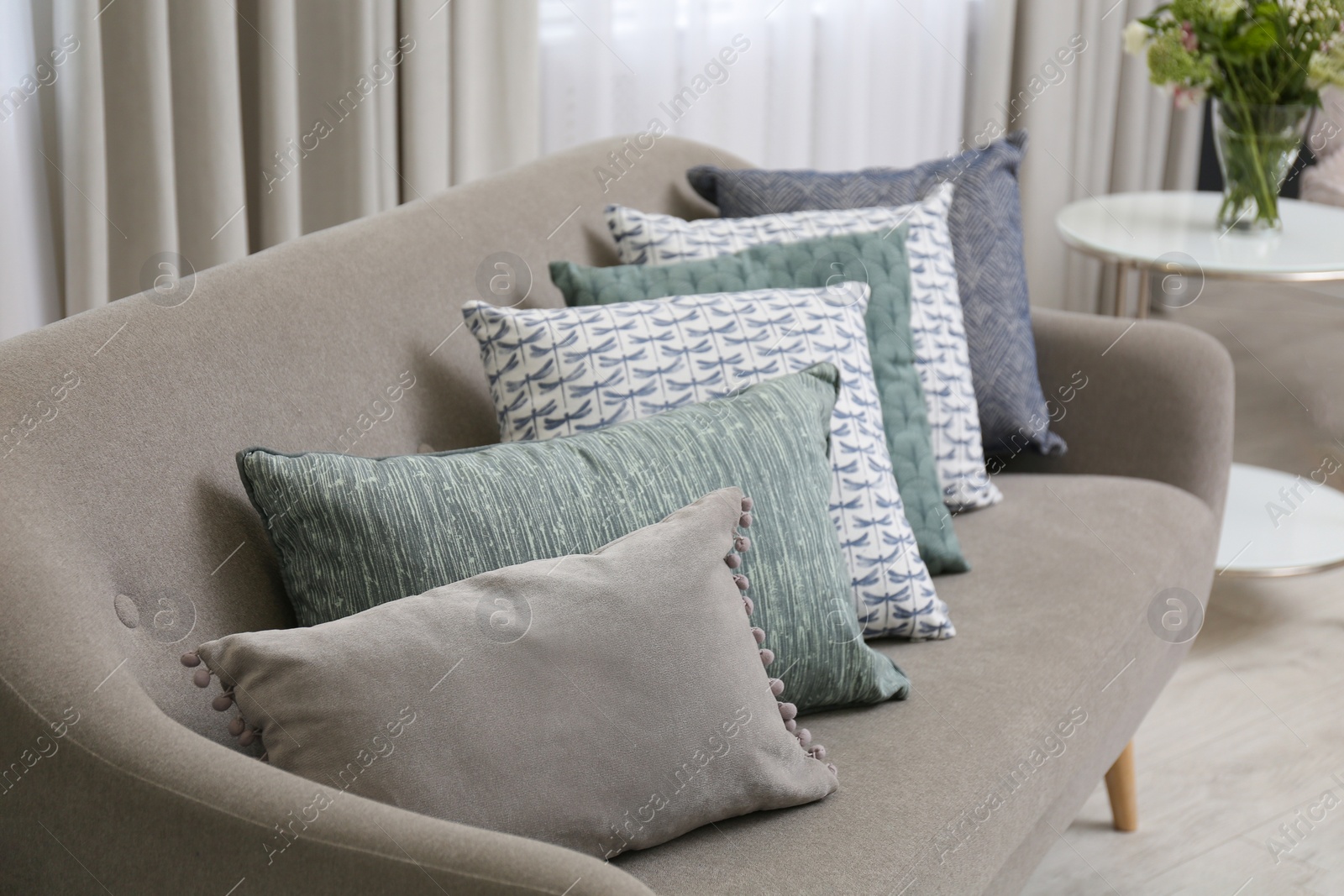 Photo of Sofa with pillows in modern living room interior