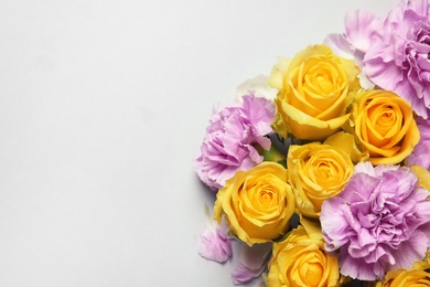 Photo of Beautiful blooming flowers on grey background, top view