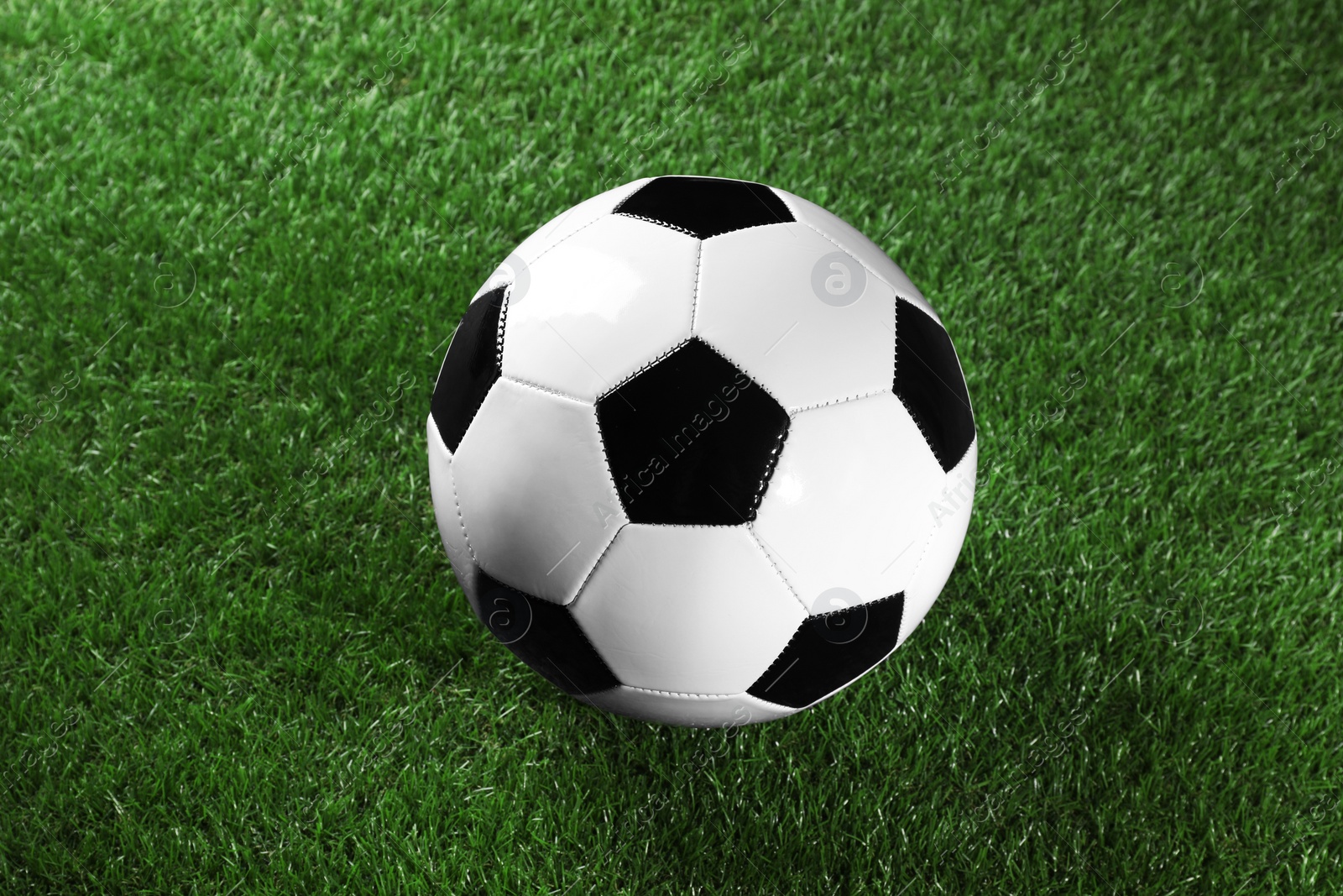 Photo of One soccer ball on green grass. Sports equipment