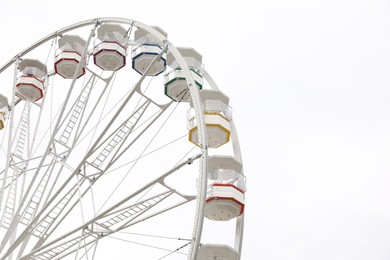 Photo of Large white observation wheel against sky, space for text