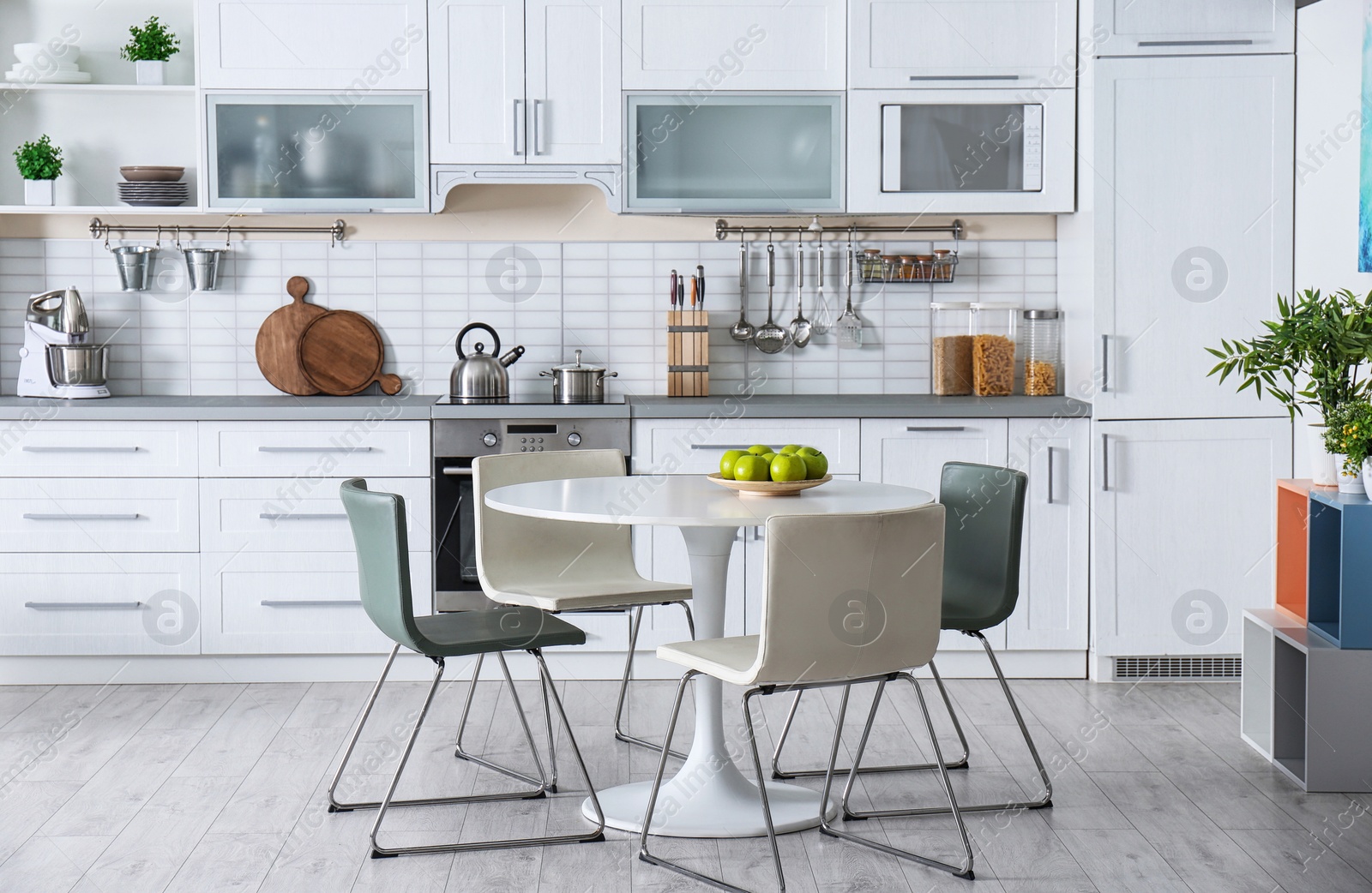 Photo of Stylish kitchen interior with dining table and chairs