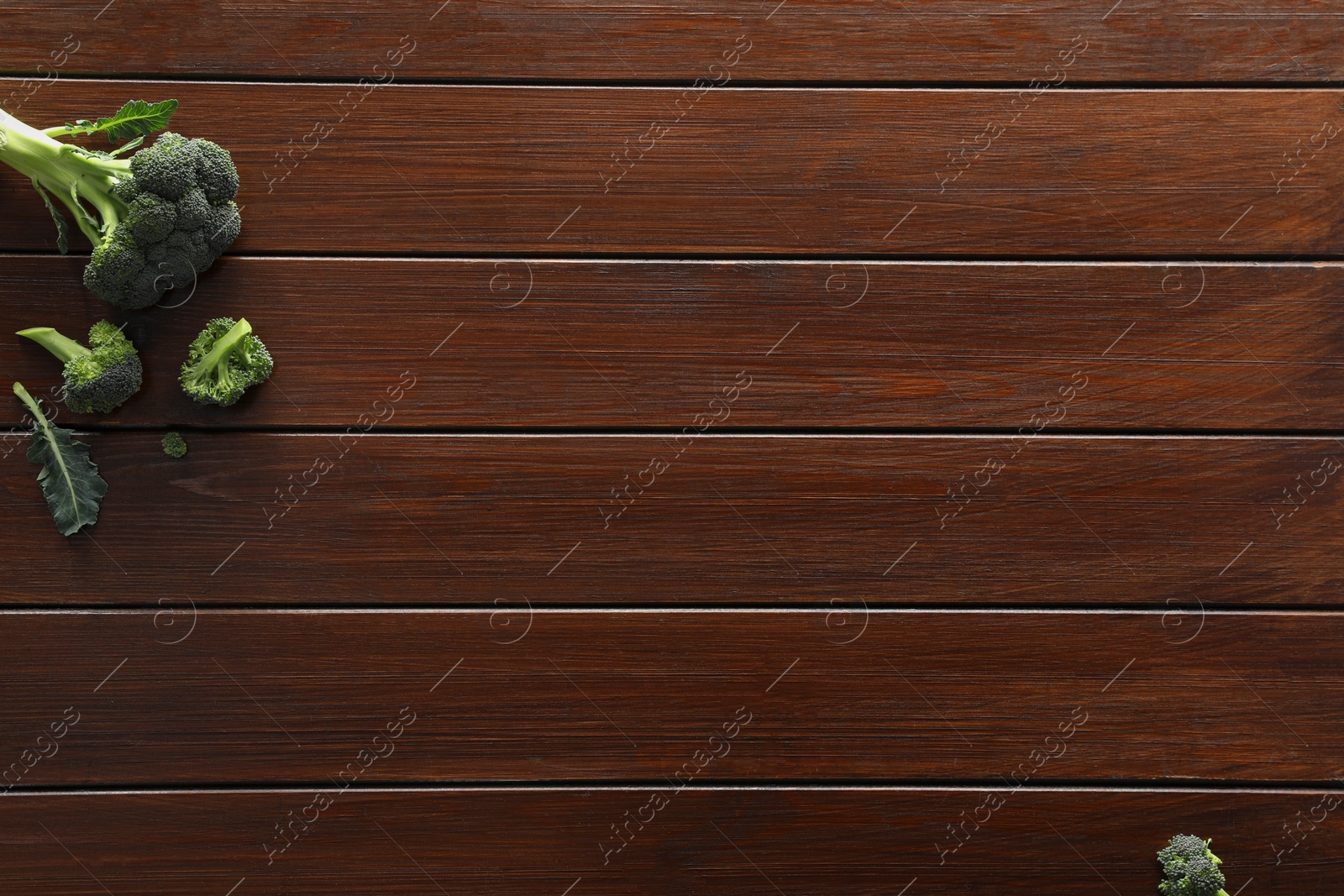 Photo of Food photography. Fresh broccoli on wooden table, flat lay with space for text