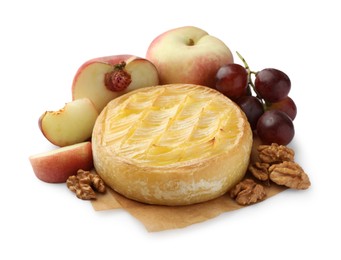 Photo of Tasty baked brie cheese with grapes, peaches and walnuts isolated on white