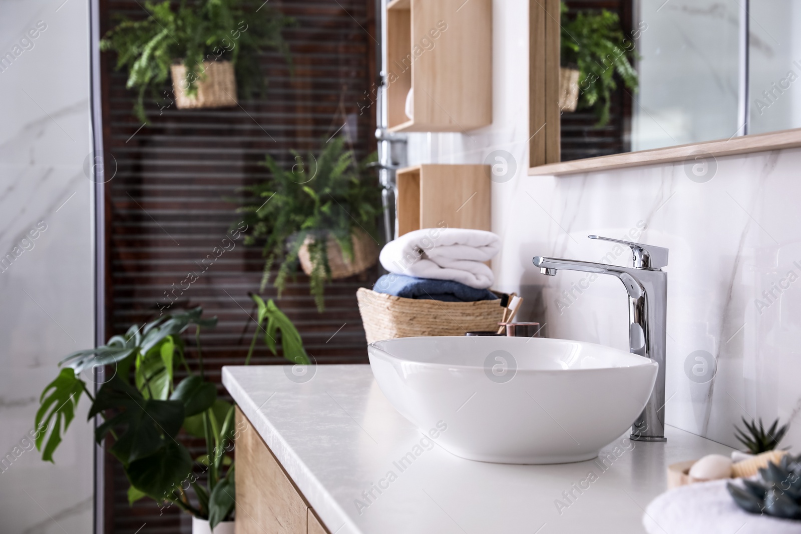 Photo of Counter with vessel sink in stylish bathroom interior. Idea for design