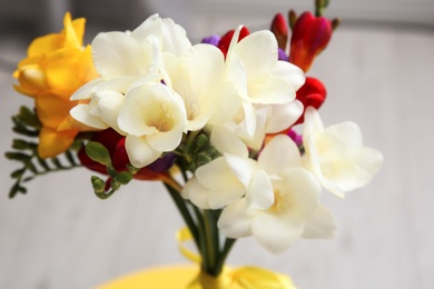 Photo of Beautiful freesia bouquet on blurred background