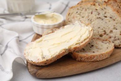 Tasty bread with butter on table, closeup