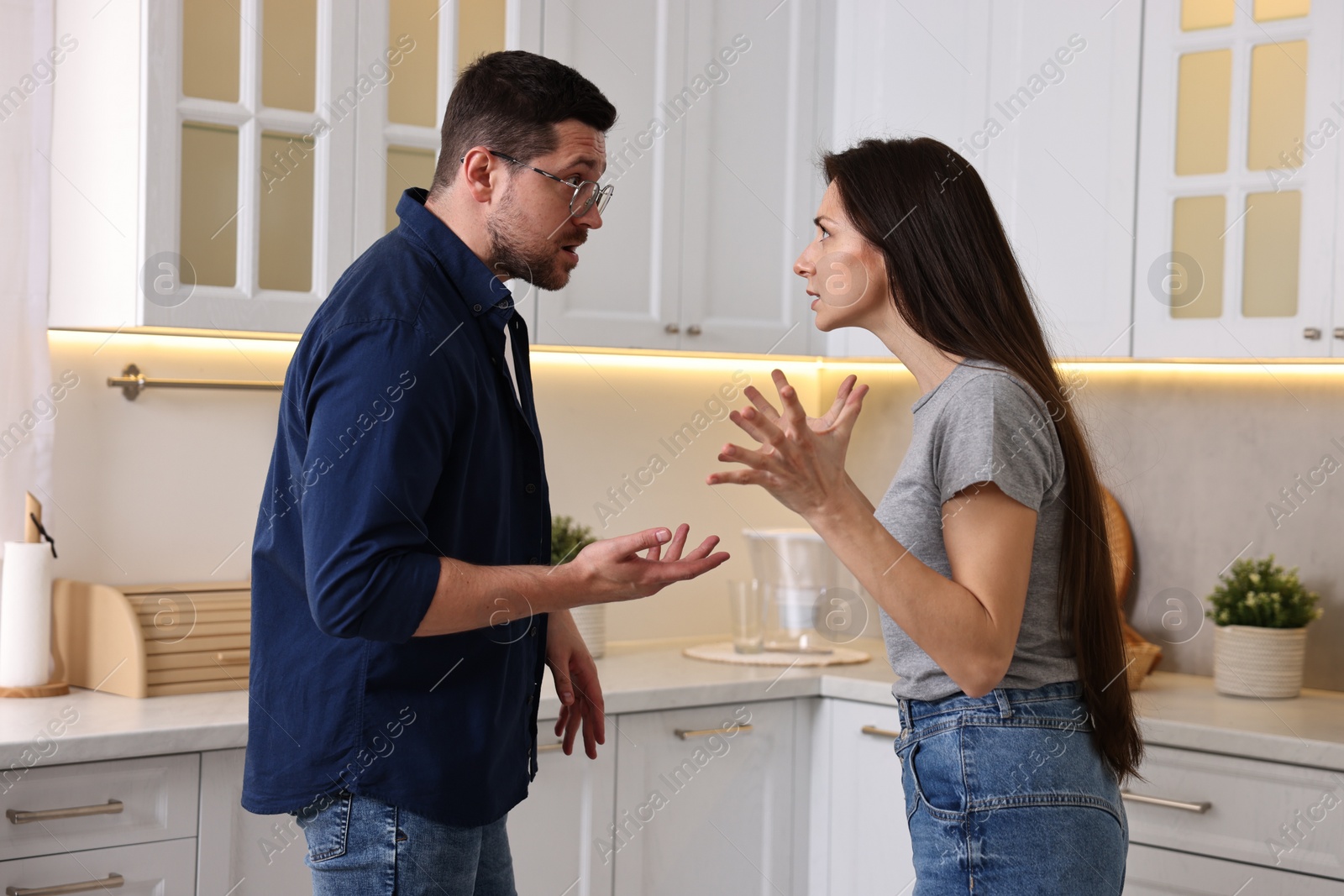 Photo of Emotional couple arguing in kitchen. Relationship problems