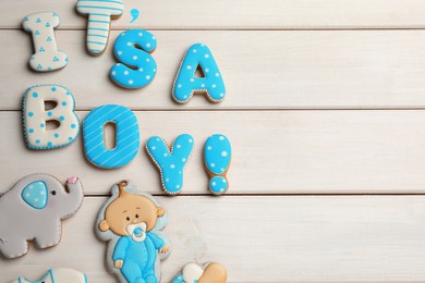 Photo of Phrase It is a boy, tasty cookies and space for text on white wooden table, flat lay. Baby shower party