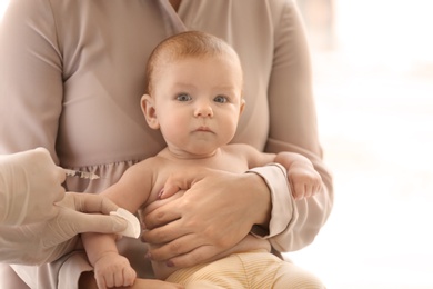 Doctor vaccinating baby in clinic