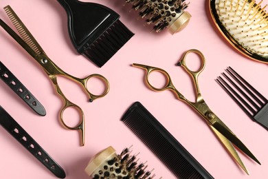 Photo of Professional hair dresser tools on pink background, flat lay