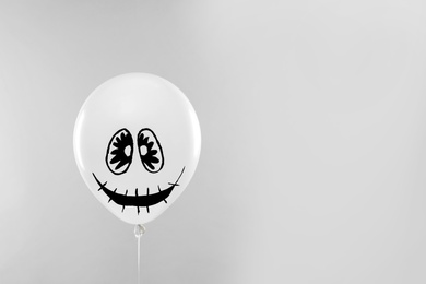 Photo of Spooky balloon for Halloween party on light grey background, space for text