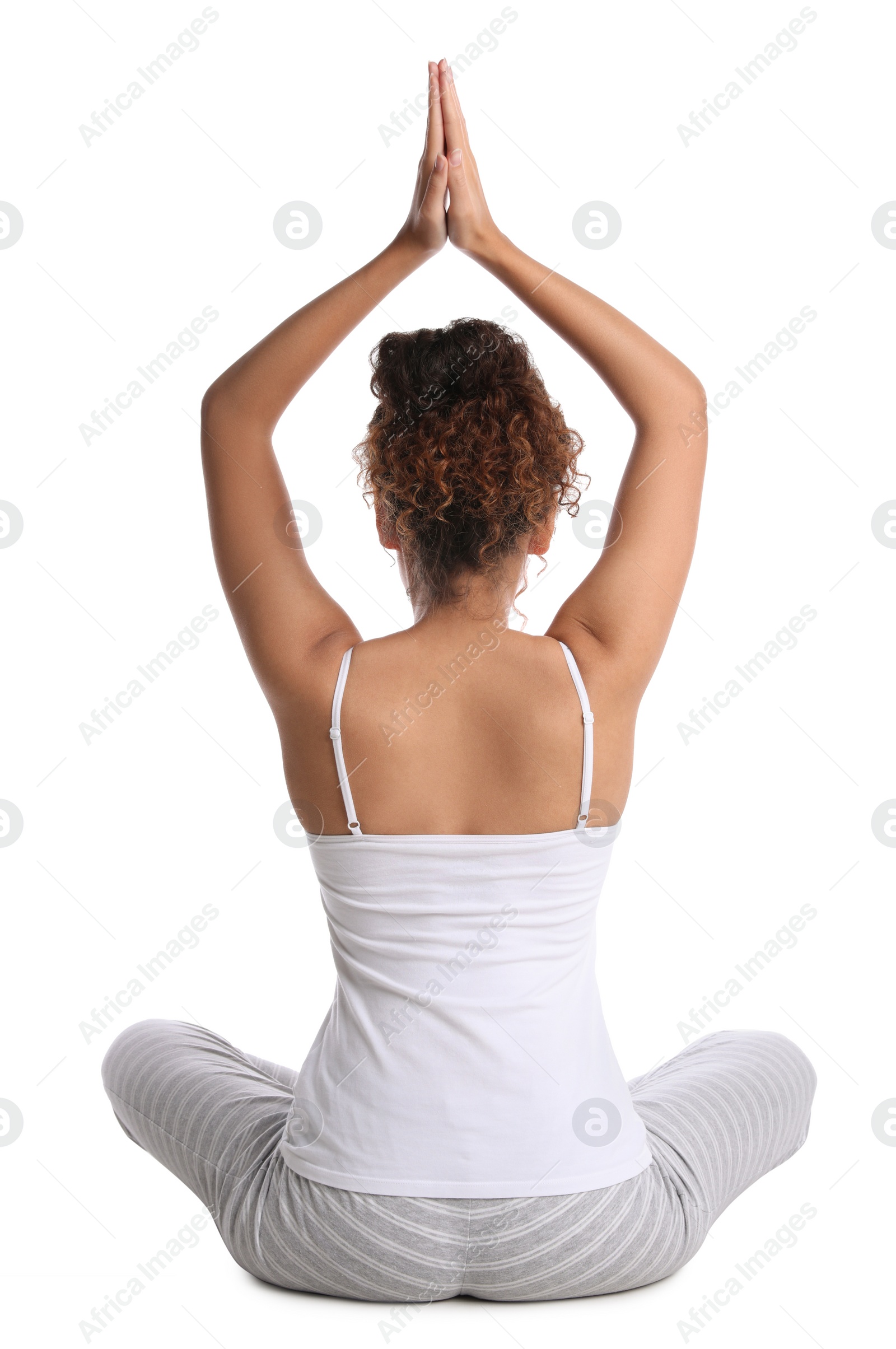 Photo of African-American woman meditating on white background, back view