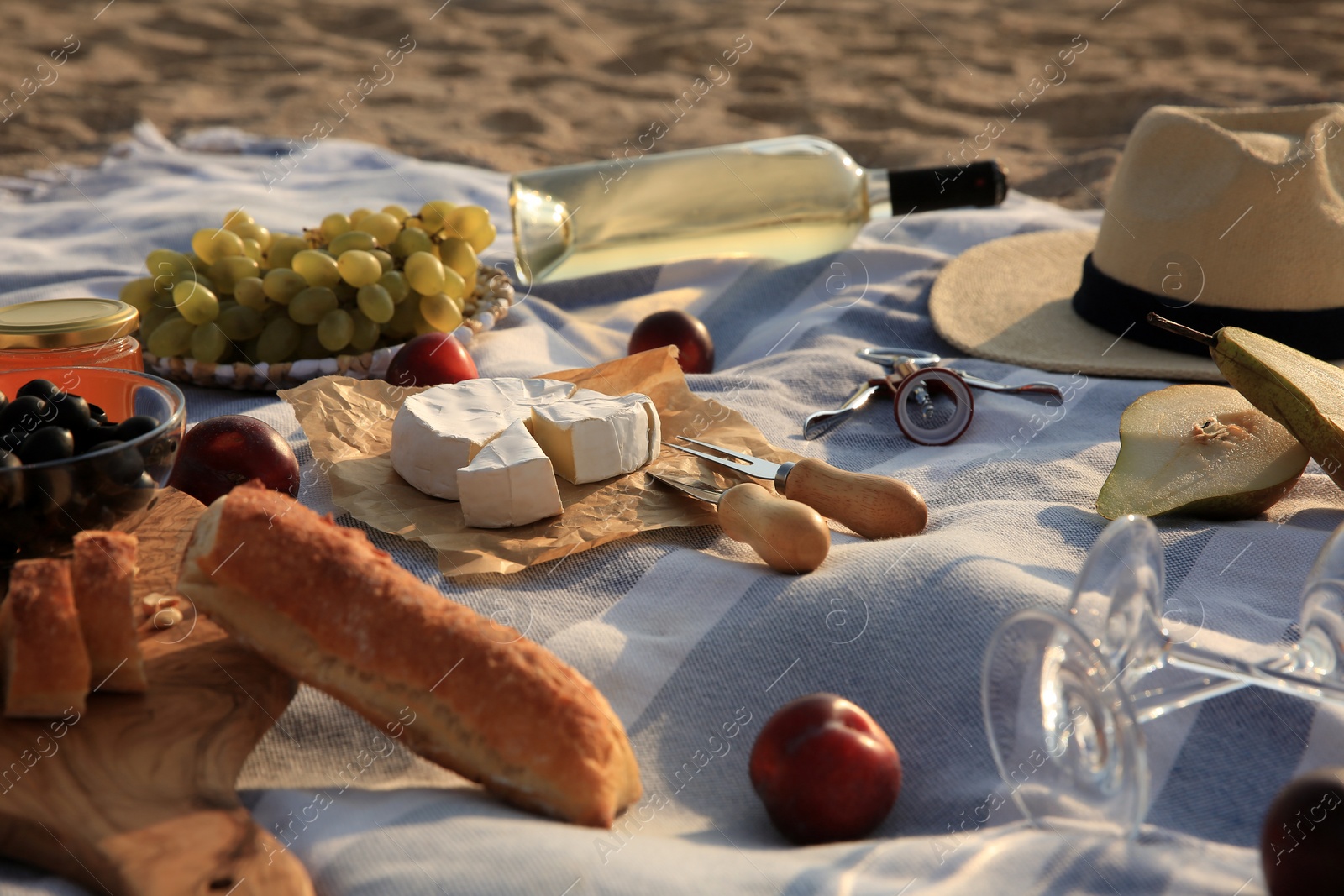 Photo of Different tasty snacks on picnic blanket outdoors