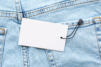 Blank tag on jeans, top view. Space for text