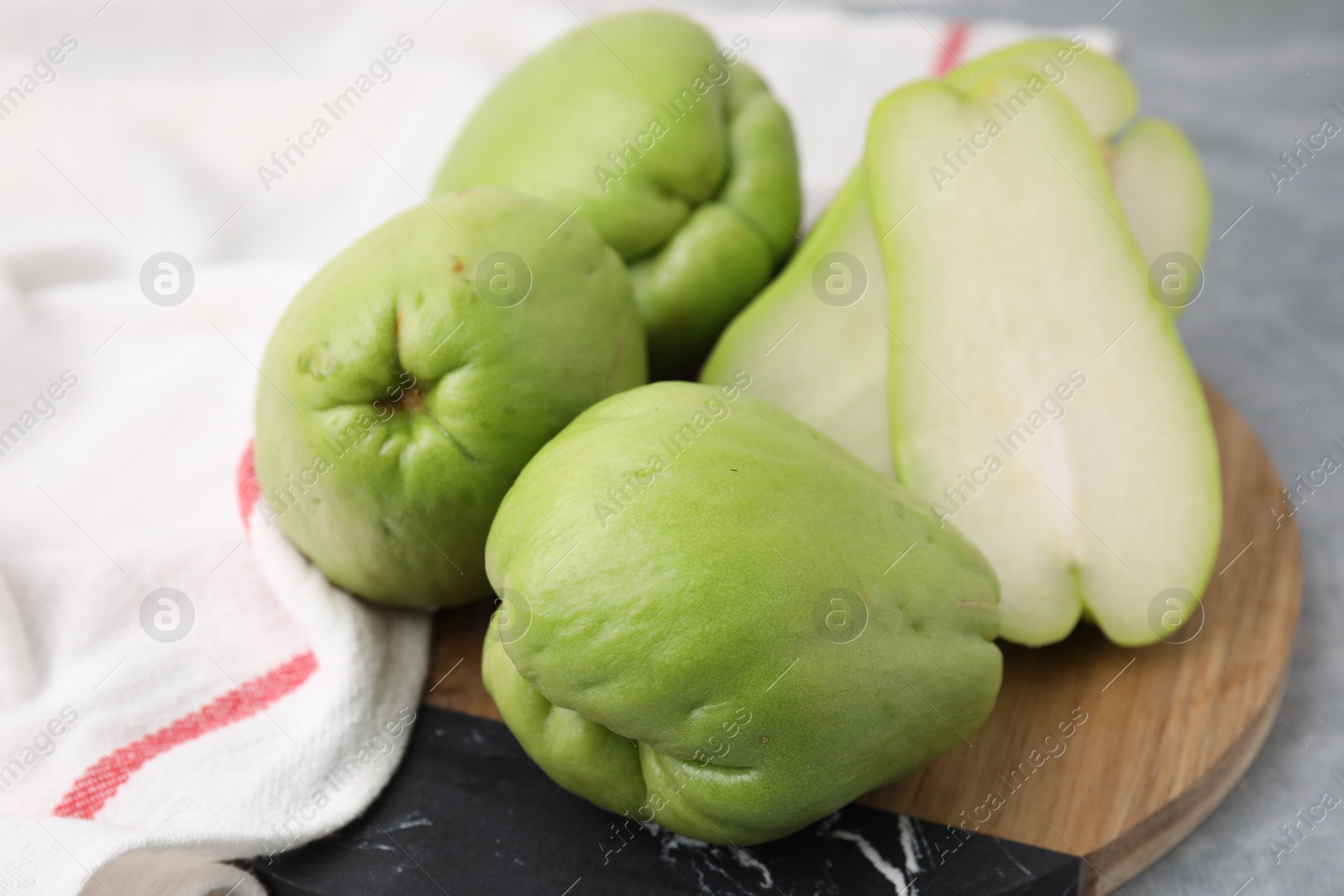 Photo of Cut and whole chayote on table, closeup