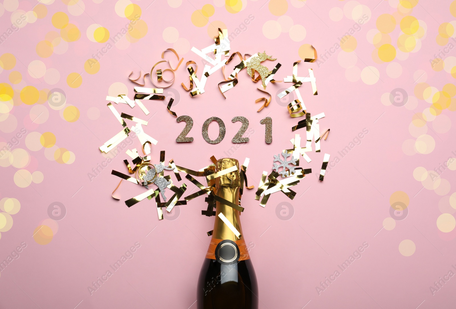 Photo of Flat lay composition with year number 2021, confetti and festive lights on pink background