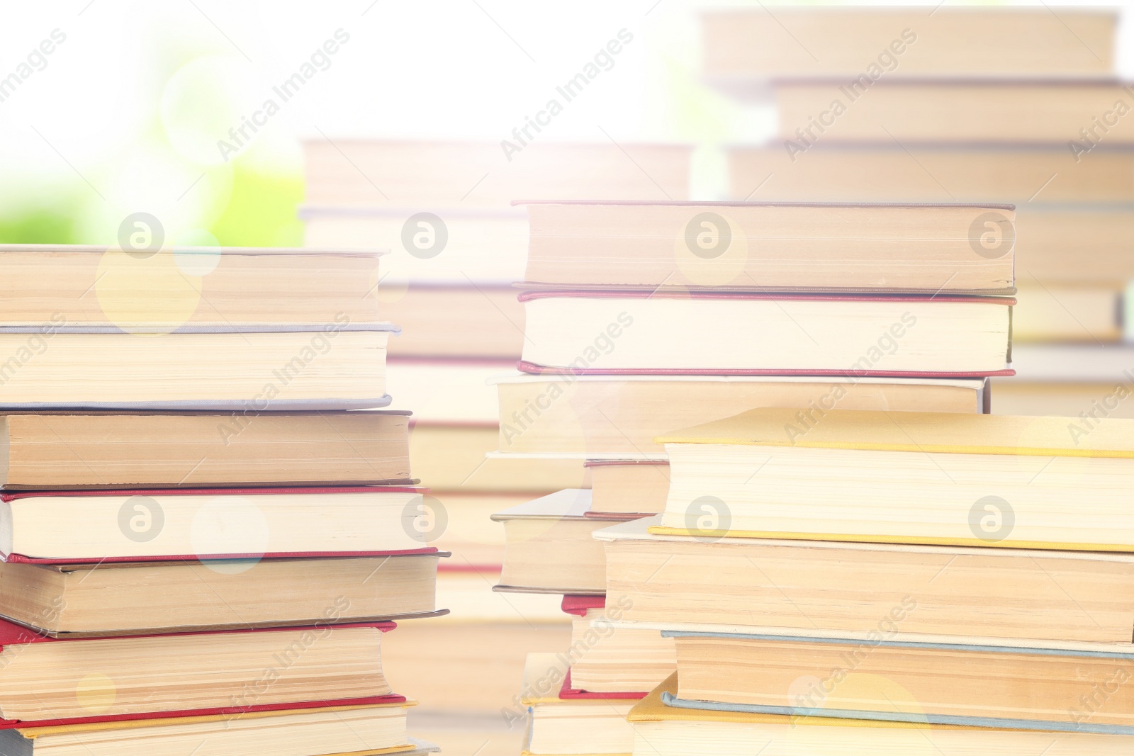 Image of Stacks of books on blurred background. Bokeh effect 