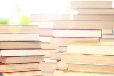 Stacks of books on blurred background. Bokeh effect 