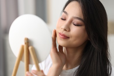 Portrait of woman with perfect skin looking indoors