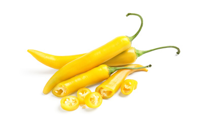 Cut and whole ripe yellow chili peppers isolated on white