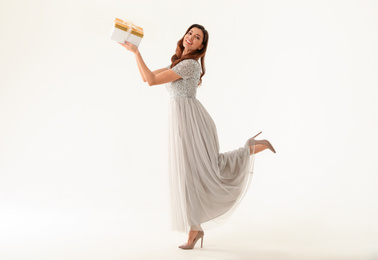 Photo of Beautiful woman with Christmas gift on white background